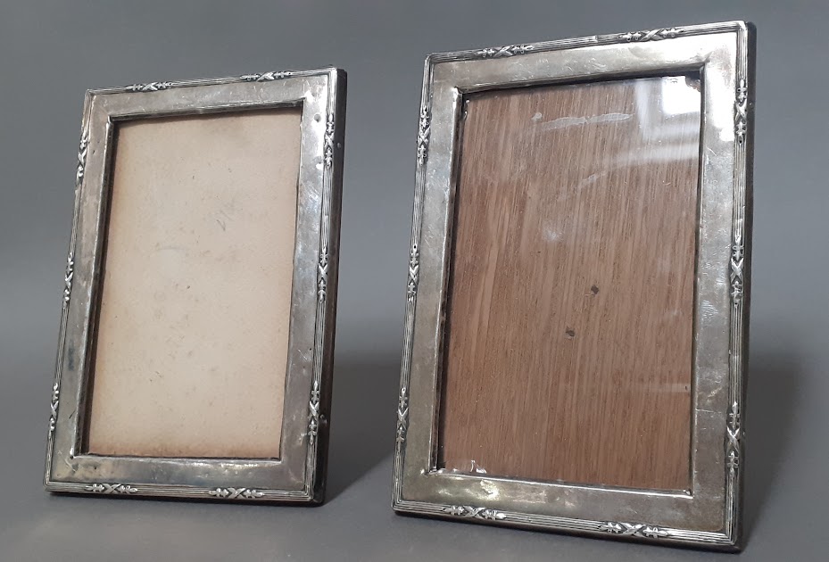 A pair of silver picture frames with oak backs.