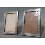 A pair of silver picture frames with oak backs.