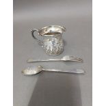 Hallmarked silver comprising a mug and a christening spoon and fork, Victoria and later, wt. 105g.