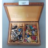 A box of assorted cufflinks and badges etc.