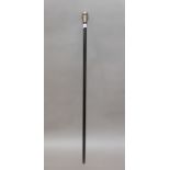 An ebonised wood and silver topped walking stick.