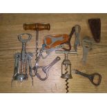 A tin of vintage corkscrews and bottle openers, etc.