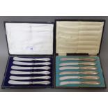 Two boxed sets of 6 silver handled butter knives.