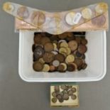 A tub ofassorted world coins to include some silver threepences & early 19th century cons etc.