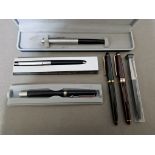 A collection of various pens, including Parker, Mont Blanc, Colibri and Papermate