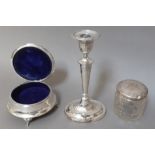 A silver bound footed box with lid, a cut glass jar with silver top and a silver candlestick,