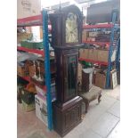 A mahogany cased grandfather clock with pendulum and weights.