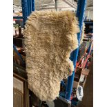 A sheepskin rug - length appx 180cm width appx 70cm