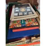 A box of world stamps and stamp albums.