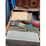 A box of loose stamps and stamp albums.