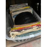 A box of 45s single records.