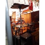 Three pieces of furniture comprising a quadrapod table, a wrought metal glass trolley and a