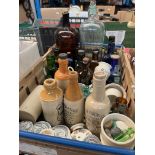 A box of vintage glass bottles & pot lids