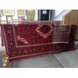 An Eastern Keshan style wool carpet, red ground, together with another smaller Eastern carpet.