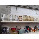 Nine late Victorian relief moulded jugs of various designs and sizes