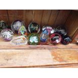 12 glass paperweights including Wedgwood Glass, Selkirk, and Caithness