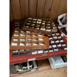 A display case and 3 smaller displays containing various thimbles to include a silver example.