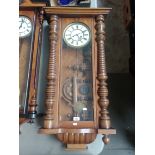 A large walnut cased Vienna wall clock with pendulum and 2 keys.