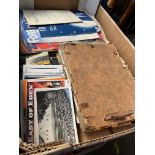 A box of mixed ephemera including postcards, photographs and song sheets.