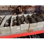 Seven trays of British motorcycle spares.