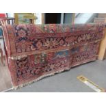 A vintage Kilim style Eastern wool carpet, red ground.