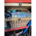 A fishing wicker basket and a box of tackle.