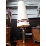 A retro teak and brass lamp with shade, height 129cm.