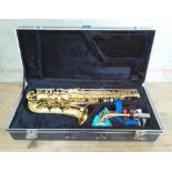 An Amati Kraslice AAS 23 alto saxophone in case + stand and box of related magazines.