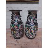 A pair of Chinese late 19th century crackle glaze vases, decorated in over enamels with battle