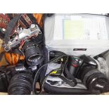 A box of assorted cameras including a Nikon D80 digital SLR with accessories, a Sigma SA 300 and a