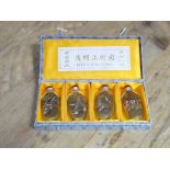 A set of four Chinese 'Riverscne' snuff bottles in case.