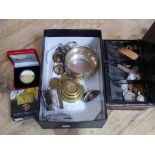 A box of assorted items including coins, brass weights marked with Chinese characters, silver plated