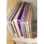A box of assorted records including The Damned, The Beatles, Frank Black, The Who, Bruce Springsteen