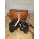 A pair of Negretti & Zambra binoculars with leather case.