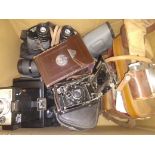 A box of assorted cameras including a Compur Contessa Nettel, various binoculars etc.