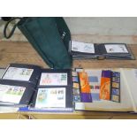 A bag of assorted FDCs and loose stamps.