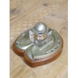 A novelty silver plated inkwell, the glass with jockey's cap lid and the base of horse shoe design