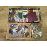 Assorted military badges and assorted medallions and a tin of coins.