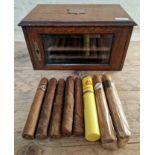 An early 20th century three drawer oak cigar box containing various cigars including 2 Monte