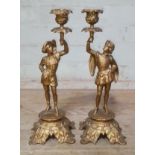 A pair of gilt painted cast metal candlesticks, height 33cm.