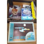 A box containing five unmade models including 2 Star Trek