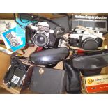 A box of assorted cameras and accessories.