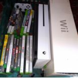 An Xbox One with games together with a Wii console.