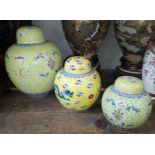 A matched set of three graduated Chinese porcelain famillie juane ginger jars, 20th century.