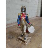 A cast metal figure entitled Drummer France 1779, silver, gilt and enamel decoration, onyx base,