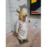 A novelty butcher's shop door stop modelled as a pig wearing chef's clothing, height 60cm.