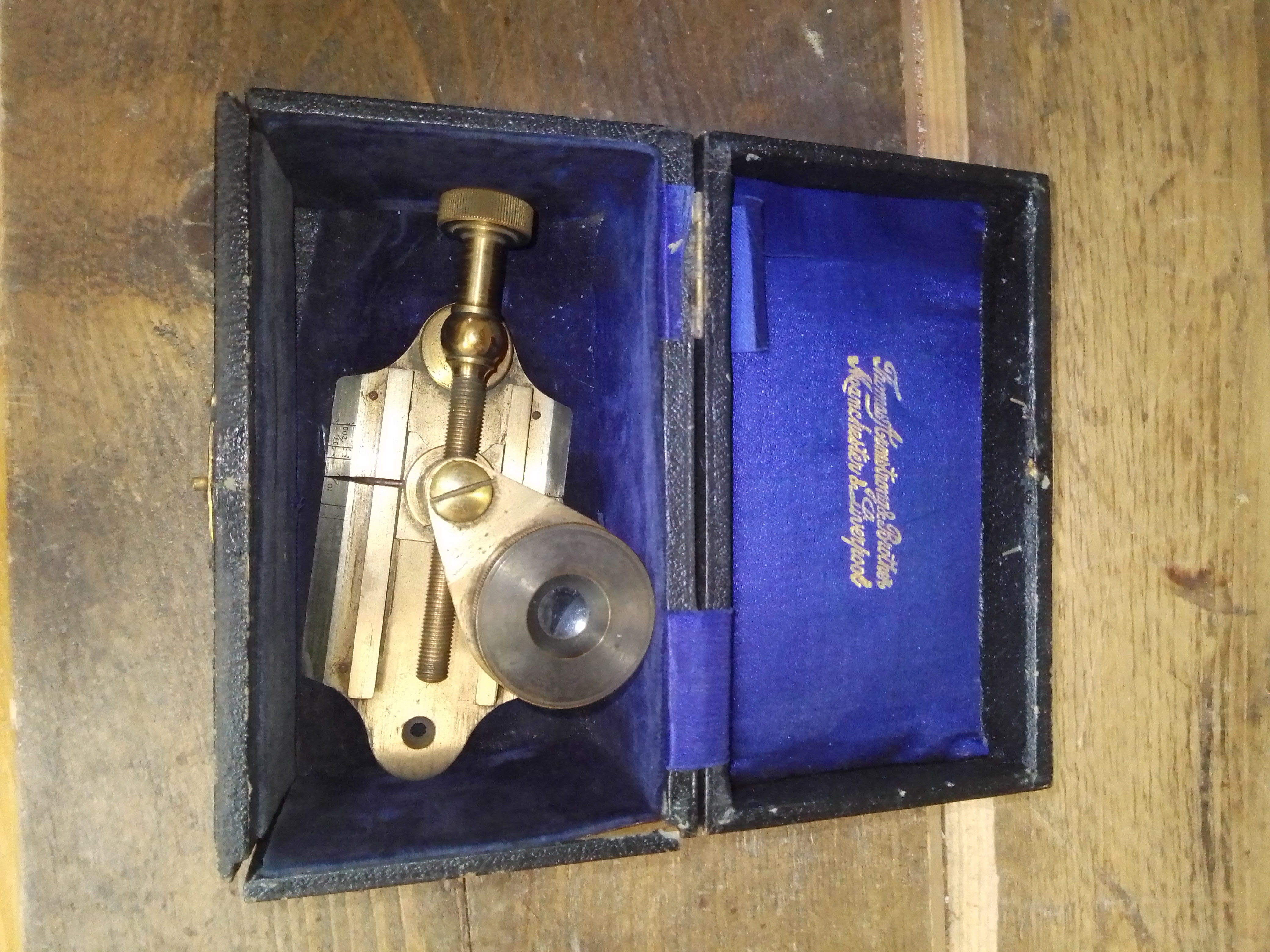 A brass thread counter with box.