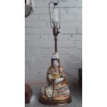 A figural pottery Eastern lamp on metal base.