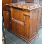 An early 20th century oak cased Singer treadle sewing machine, the cabinet fitted with drawers