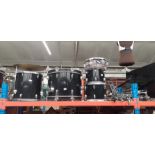 A CB drum kit comprising bass drum, two tom toms and floor tom, two cymbals, hi-hat, pedals and